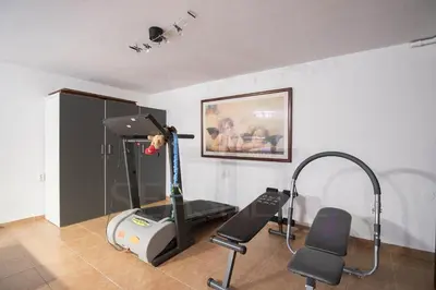 a room with an exercise bike and a treadmill at Rubi in Vilamoura