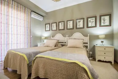 two beds sitting next to each other in a bedroom at Rubi in Vilamoura