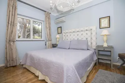 a bedroom with a white bed and a window at Rubi in Vilamoura