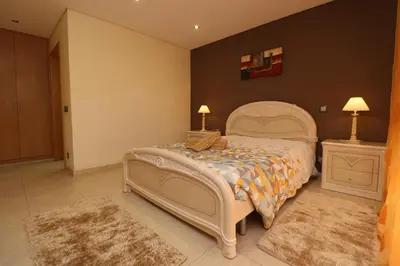 a bedroom with a large bed and two night stands at Alsol in Quarteira