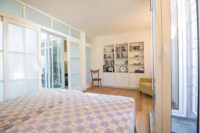 a bedroom with a bed and a window and a chair at Villa Lake View in Quarteira