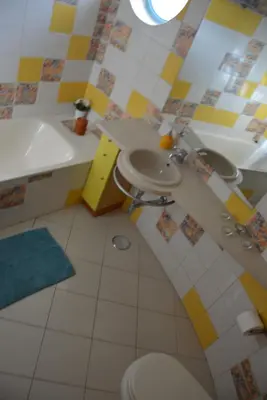 a bathroom with a sink and a toilet and a tub at Penthouse Marina in Albufeira