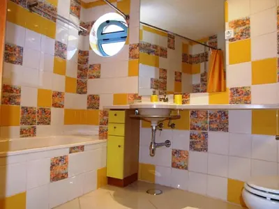 a bathroom with a sink and a tub and a toilet at Penthouse Marina in Albufeira