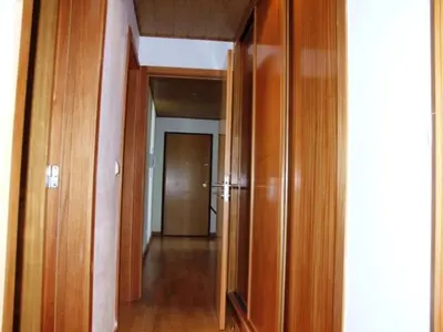 a hallway with wooden walls and a hallway with a mirror at Penthouse Marina in Albufeira