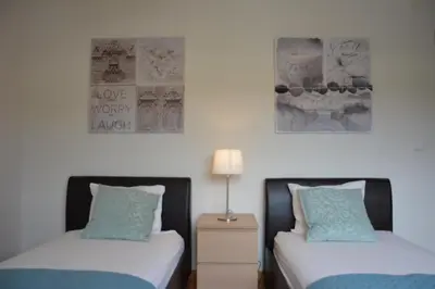 two beds sitting next to each other in a bedroom at Penthouse Marina in Albufeira