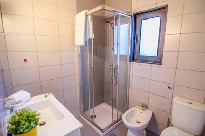a bathroom with a toilet and a sink and a mirror at Villa Beira Golf in Quarteira