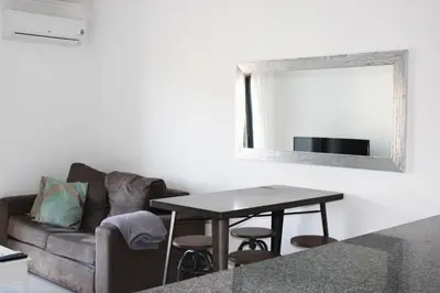 a living room with a couch and a table with a mirror at Apartment with terrace Albufeira Olhos de Água in Albufeira