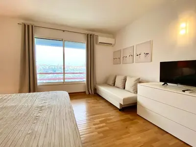 a living room with a couch and a television at Home Out Luxury Marina Apartment - 2 Bedrooms Sea View in Vilamoura