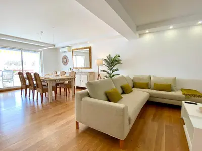a living room with a couch and a dining room at Home Out Luxury Marina Apartment - 2 Bedrooms Sea View in Vilamoura