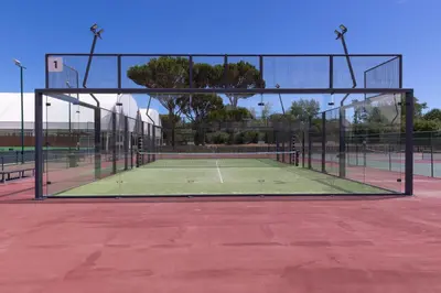 a tennis court with a net on a tennis court at Villa V2 Duplex - Vilamoura Tennis in Quarteira