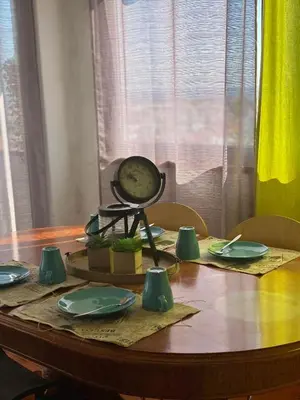 a table with a clock on top of it at Algarve Vacations Flat in Albufeira