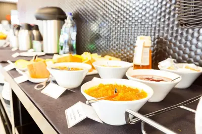 a buffet with bowls of food on a counter at Faro Boutique Hotel in Faro