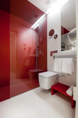 a red bathroom with a toilet and a shower at Faro Boutique Hotel in Faro