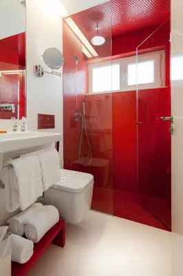 a red bathroom with a toilet and a shower at Faro Boutique Hotel in Faro
