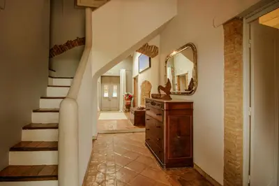 a hallway with a staircase and a mirror and a dresser at FLH Belaventura Villa in Boliqueime