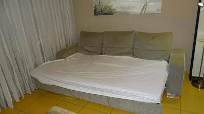 a bed with white sheets and pillows in a room at AlgarveFlat in Albufeira
