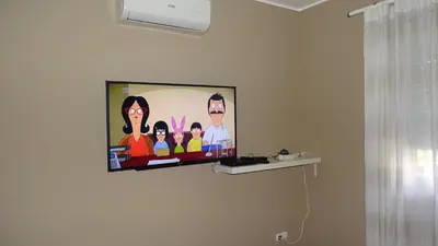 a flat screen tv hanging on a wall at AlgarveFlat in Albufeira