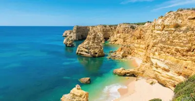 a view of a rocky coast with a sandy beach at Apartment in Algarve,Vilamoura in Vilamoura
