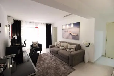 a living room with a couch and a tv at Apartment in Algarve,Vilamoura in Vilamoura