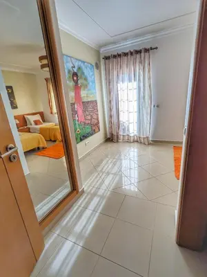 a living room with a large painting on the wall at Farm Village- Townhouse 2 mins from Old Town Albufeira in Albufeira