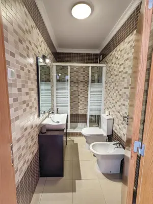 a bathroom with two toilets and a sink and a tub at Farm Village- Townhouse 2 mins from Old Town Albufeira in Albufeira