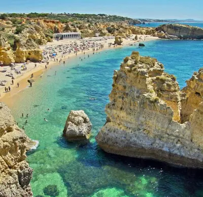 a group of people on a beach in the water at Farm Village- Townhouse 2 mins from Old Town Albufeira in Albufeira