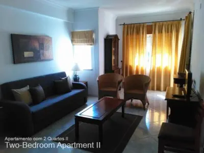 a living room with a couch and a table at Akisol Vilamoura Sun III in Vilamoura