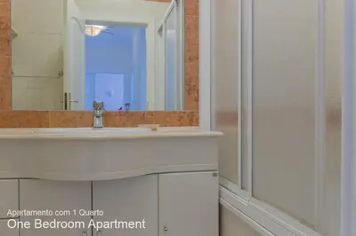 a bathroom with a sink and a mirror at Akisol Vilamoura Sun III in Vilamoura