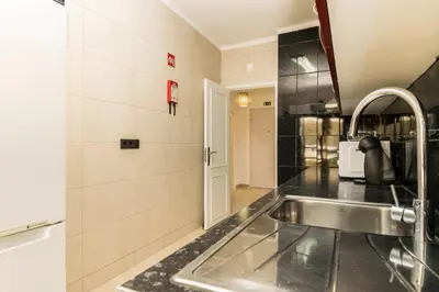 a kitchen with a sink and a counter at Akisol Quarteira Sunny in Quarteira