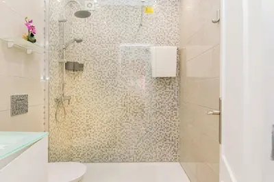 a bathroom with a shower with a toilet at Akisol Quarteira Sunny in Quarteira