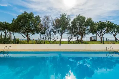 a swimming pool with trees in the background at Akisol Quarteira Sunny in Quarteira