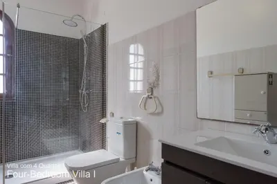 a bathroom with a sink and a toilet and a shower at Akivillas Quarteira Rose in Quarteira