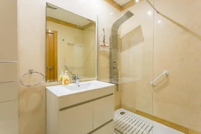 a bathroom with a sink and a glass shower at Quinta da Barracuda by Golden Zenith in Albufeira