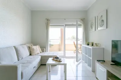 a balcony with a wooden table and chairs at Quinta da Barracuda by Golden Zenith in Albufeira