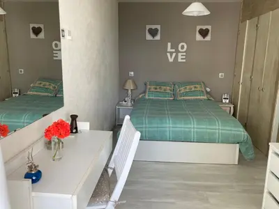 a bedroom with two beds and a table with flowers at Albufeira Portugal Maria appt in Albufeira