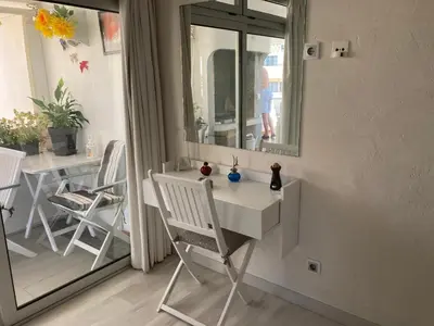a white desk in a room with a table and chairs at Albufeira Portugal Maria appt in Albufeira