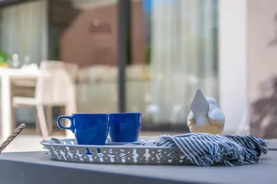 a tray with two blue cups on a table at Villas Novochoro - Large Garden- Heatable Pool by DreamvillasAlbufeira in Albufeira