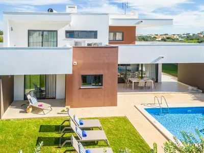 an image of a house with a swimming pool at Villas Novochoro - Large Garden- Heatable Pool by DreamvillasAlbufeira in Albufeira
