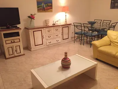 a living room with a couch and a table at Marina Vilamoura Apartment in Vilamoura
