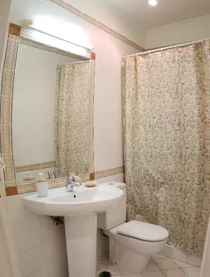 a bathroom with a sink and a toilet and a shower at Marina Vilamoura Apartment in Vilamoura