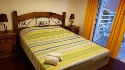 a bedroom with a bed with two night stands and a window at Marina Vilamoura Apartment in Vilamoura