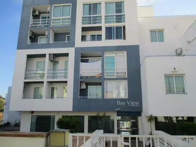 a large white building with a bay view sign on it at Bay View Apartment Albufeira in Albufeira