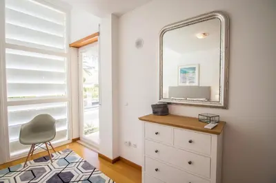 a mirror and a dresser in a room with a window at Villa Granada in Almancil