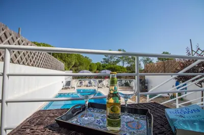 a villa with a swimming pool with chairs and umbrellas at Villa Granada in Almancil