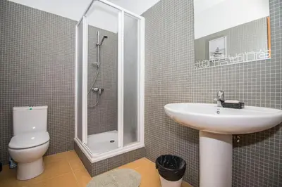 a bathroom with a sink and a toilet and a tub at Villa Granada in Almancil