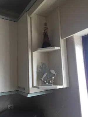 a cabinet with a shelf with a figurine on it at Mare Viva Beach Apartment in Quarteira
