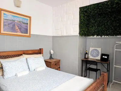 a bed with a wooden headboard and two towels on it at RIA Terrace in Faro