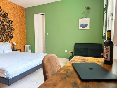 a desk with a laptop and a chair and a fan at RIA Terrace in Faro