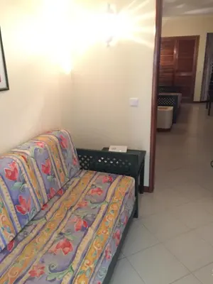 a couch sitting in a room with a table at Bellavista Ténis Clube - Studio Sea View in Albufeira