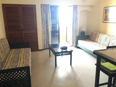 a living room with a couch and a table at Bellavista Ténis Clube - Studio Sea View in Albufeira